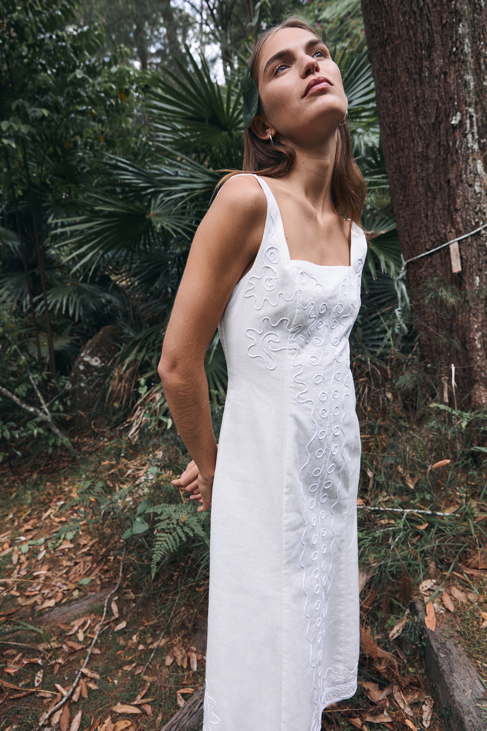 model wearing white dress in rainforest