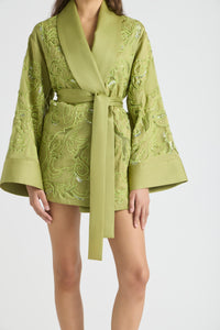 Green embroidered robe on a white background